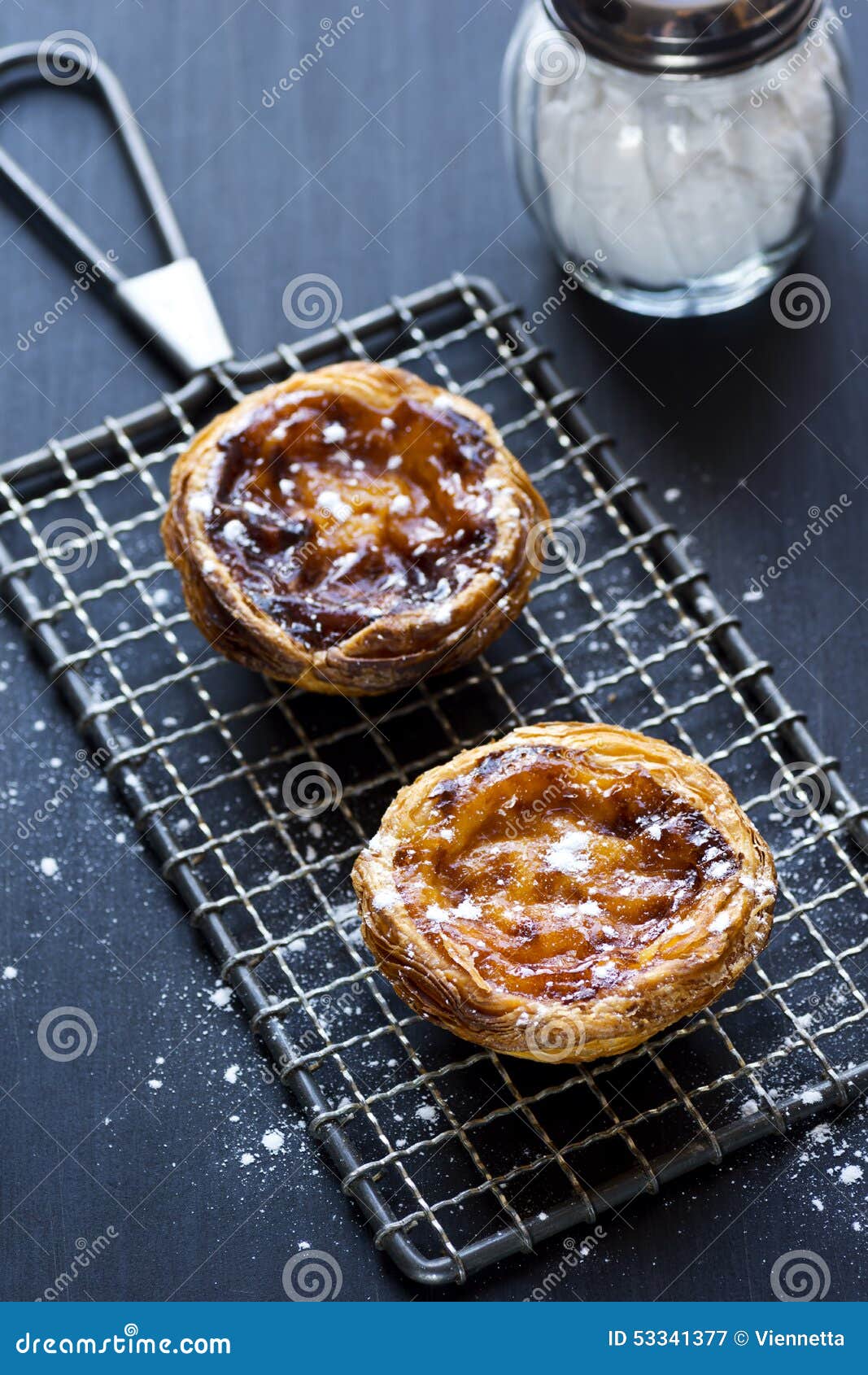 pasteis de nata, or portuguese custard tarts, on a cooling rack