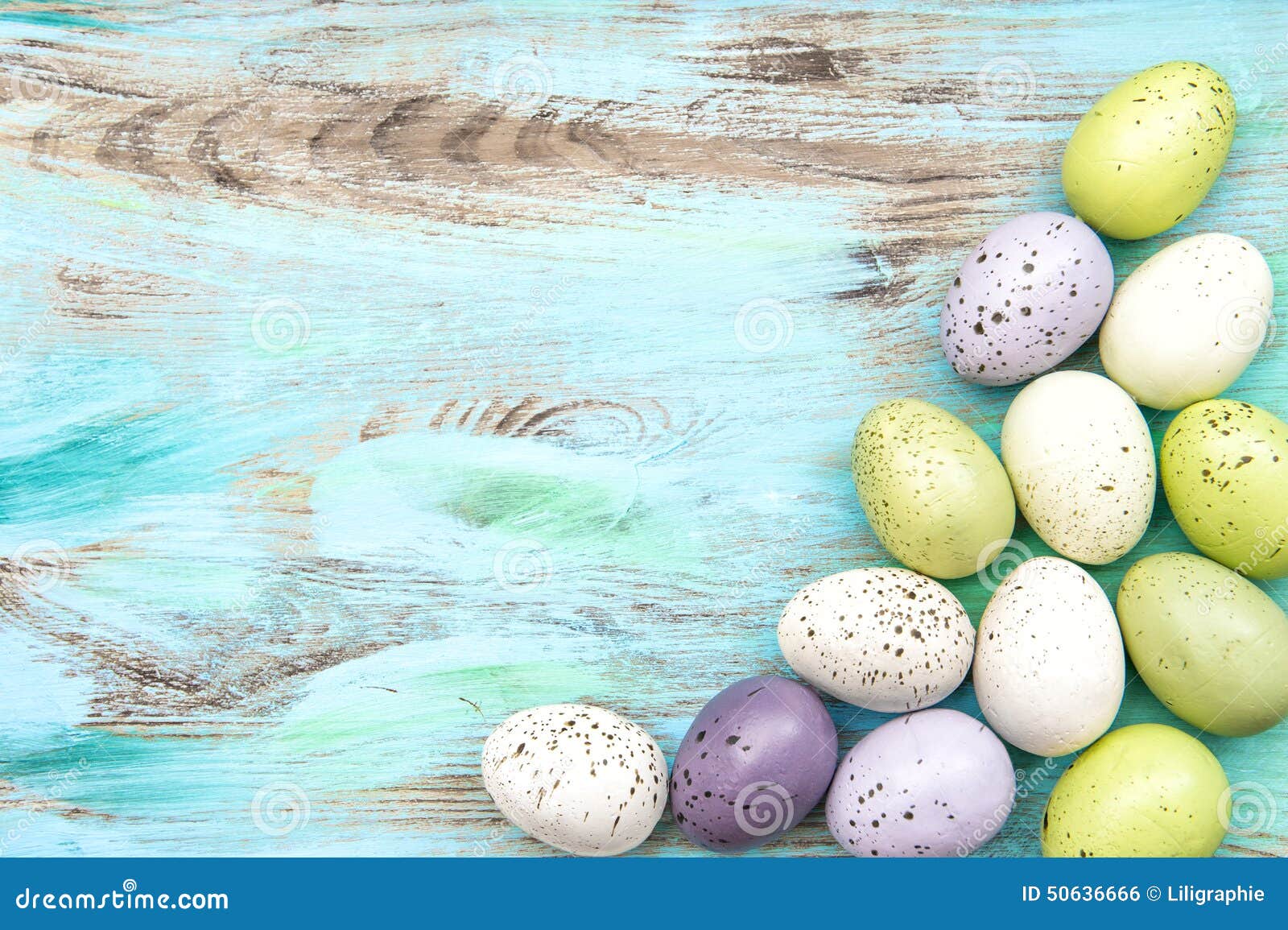 pastel colored easter eggs on wooden background