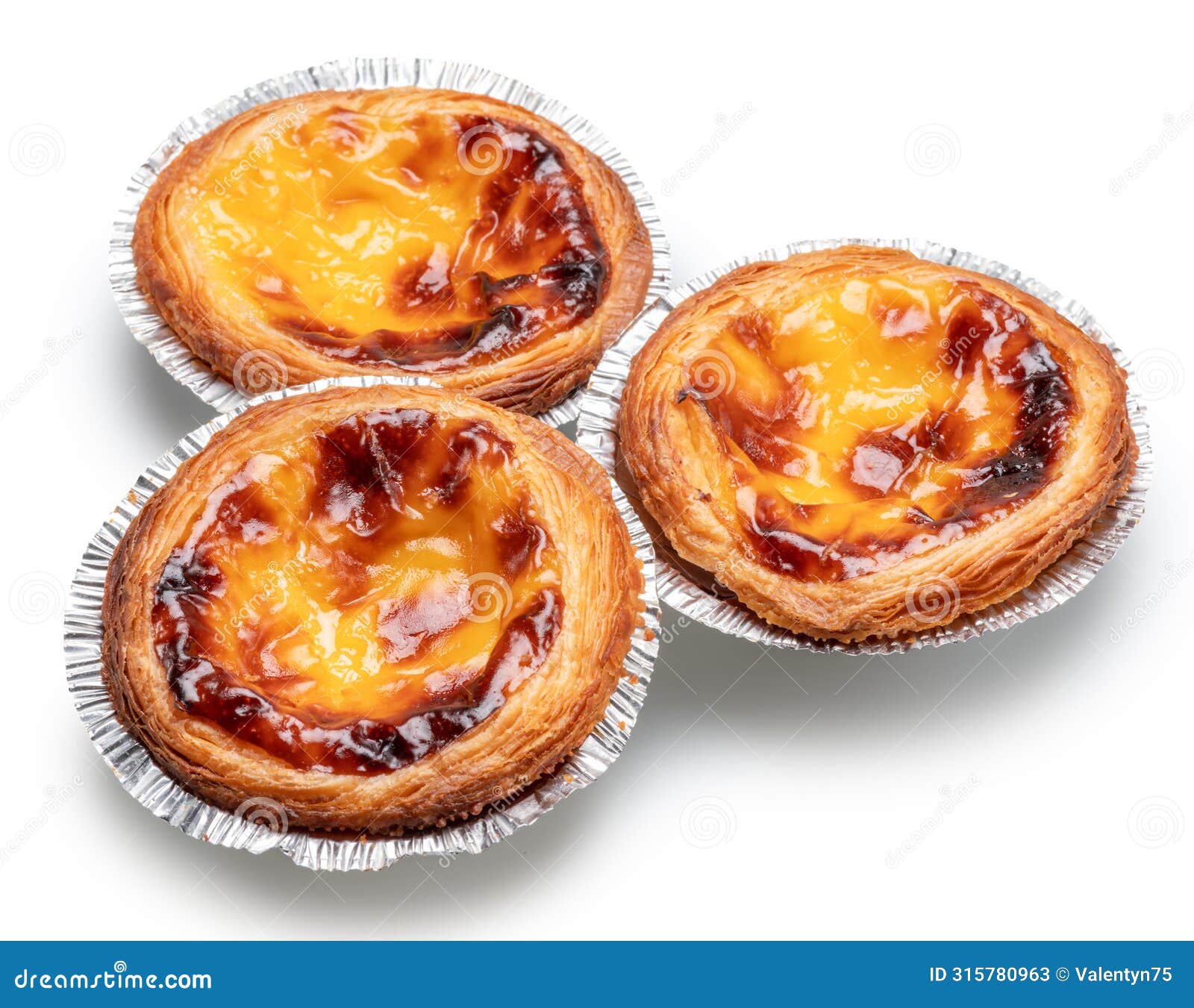 pastel de nata tarts in foil cups on white background. file contains clipping path