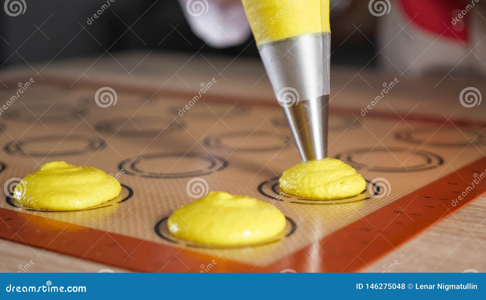 Pastry Chef Is Cooking Macaroons Pouring Dough On Stencil