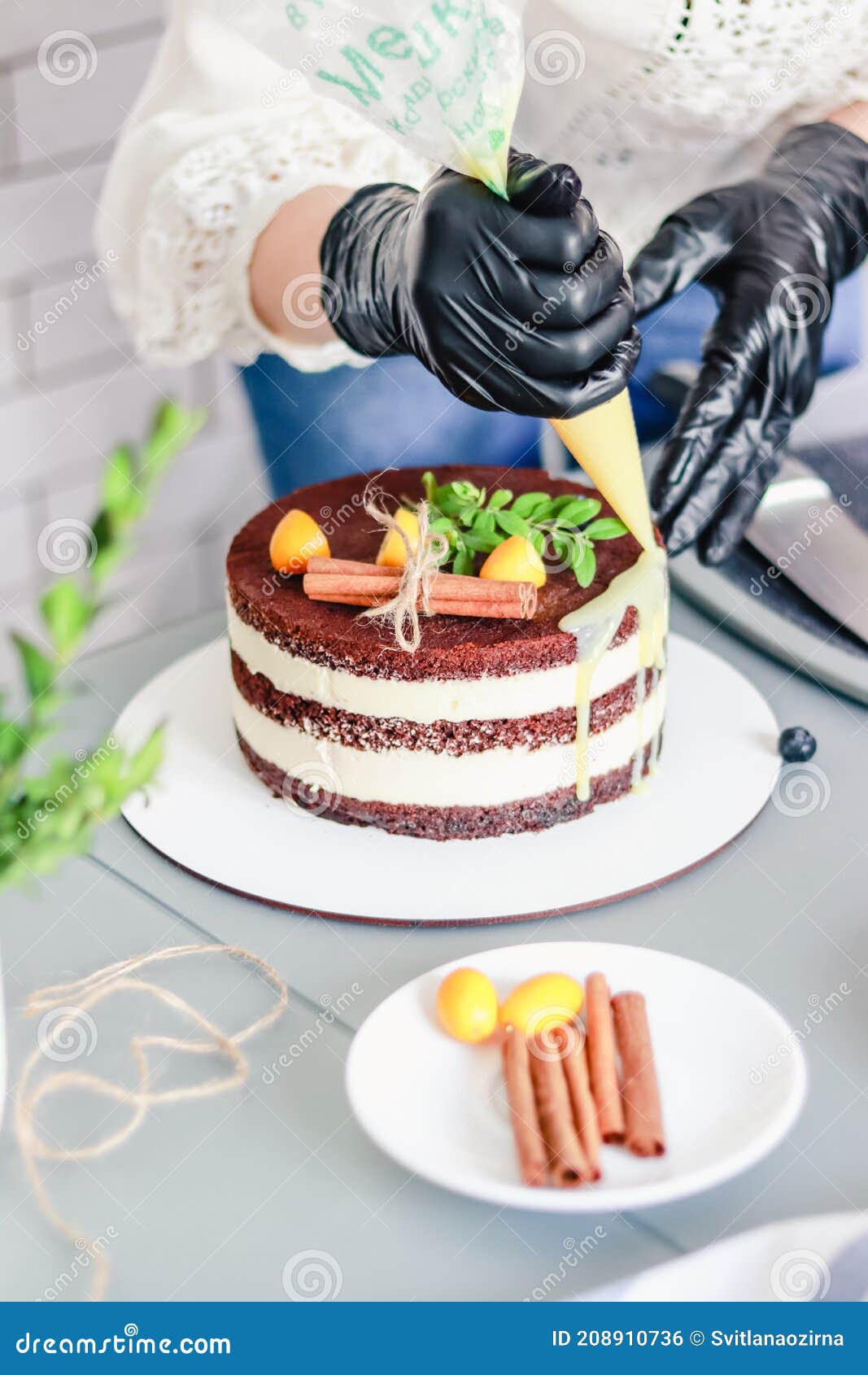 A Pastry Chef Decorates a Chocolate Naked Cake with Drips of White ...