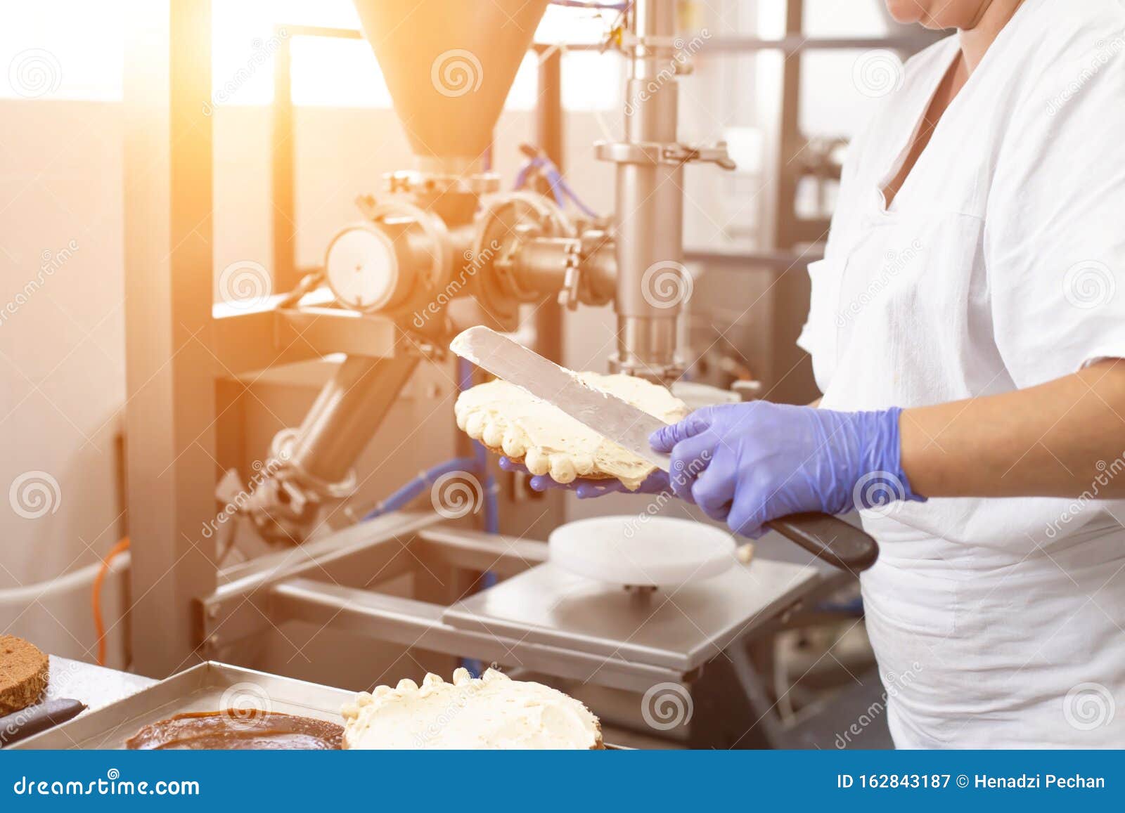 The Pastry Chef Makes Cake Using Modern Equipment for the Production of