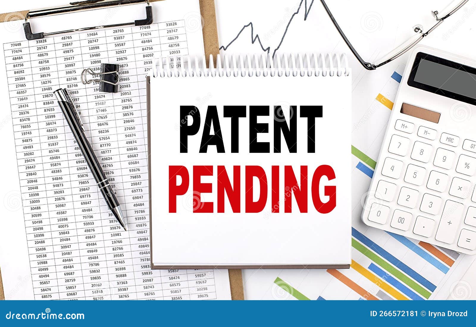 PATENT PENDING Text on Notebook with Chart, Calculator and Pen Stock