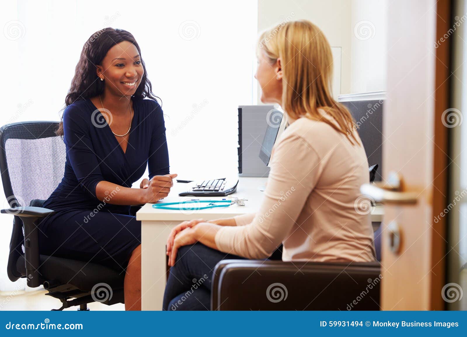 patient having consultation with female doctor in office