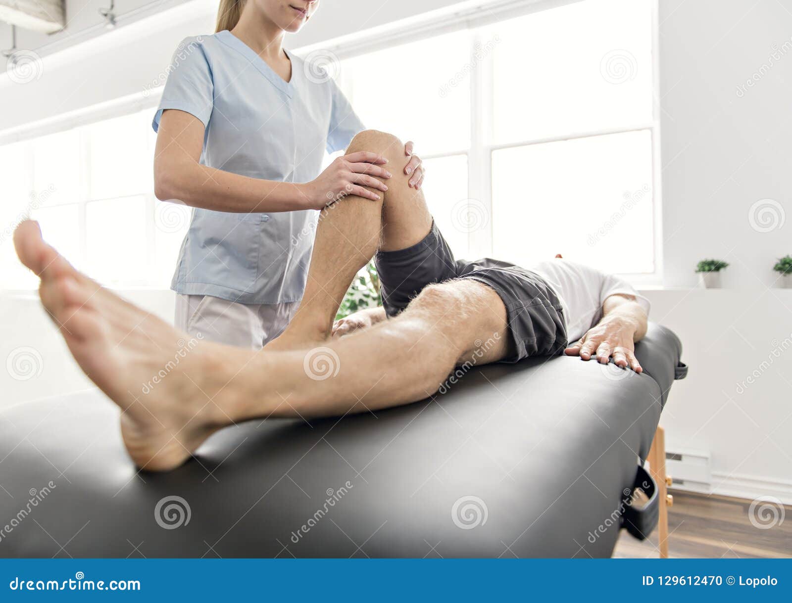 patient at the physiotherapy doing physical exercises with his therapist