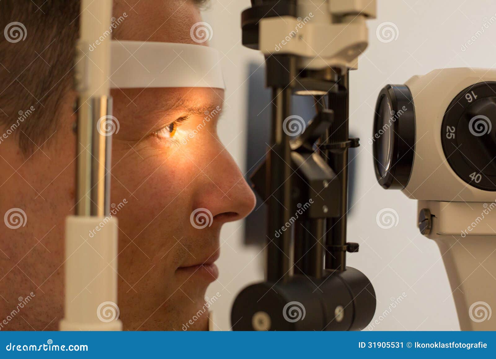 patient at slit lamp of optician or optometrist