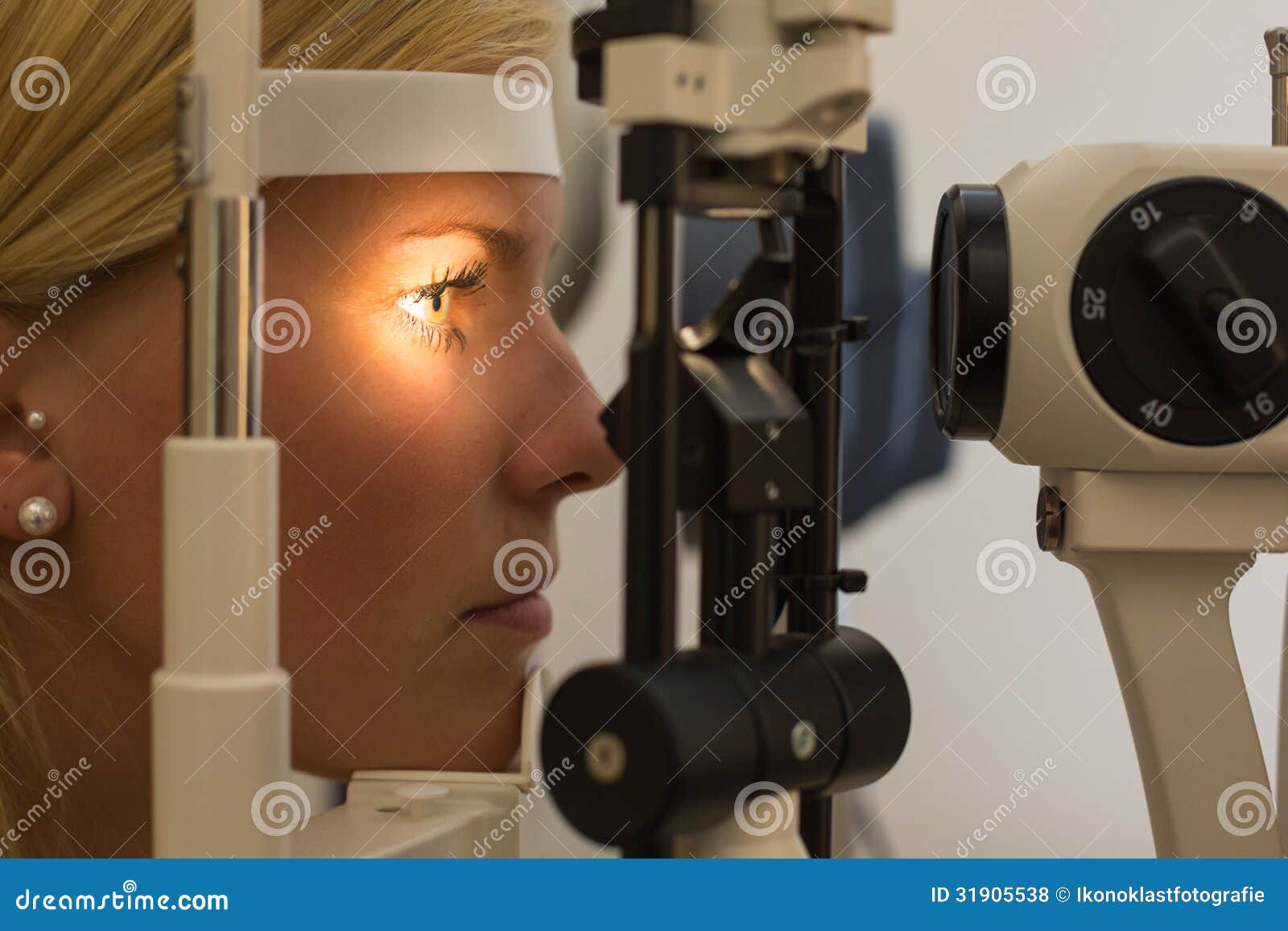 patient at slit lamp of optician or optometrist