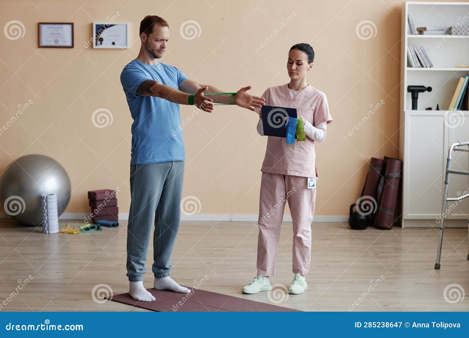 Patient Training with Rubber Band during Rehabilitation Stock Image