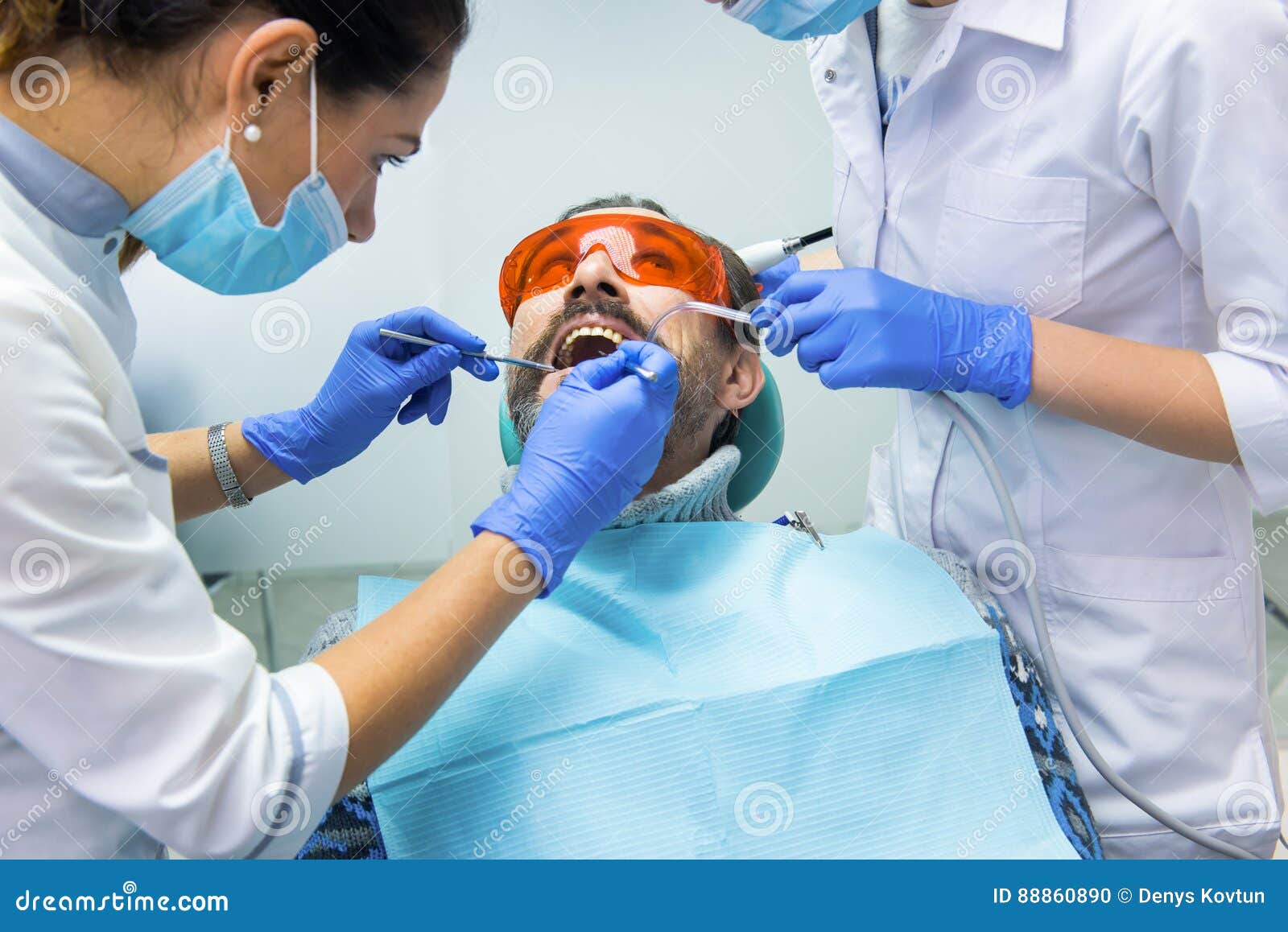 Patient and two dentists. stock photo. Image of experienced 88860890