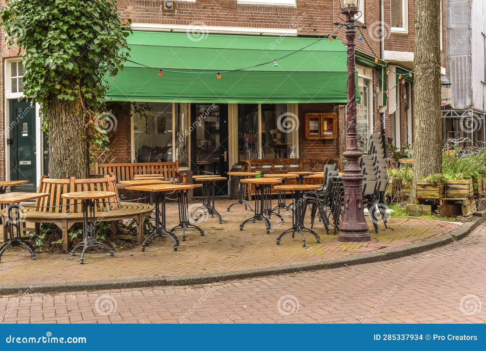 A Patio with Tables and Chairs Outside of a Restaurant Stock Photo