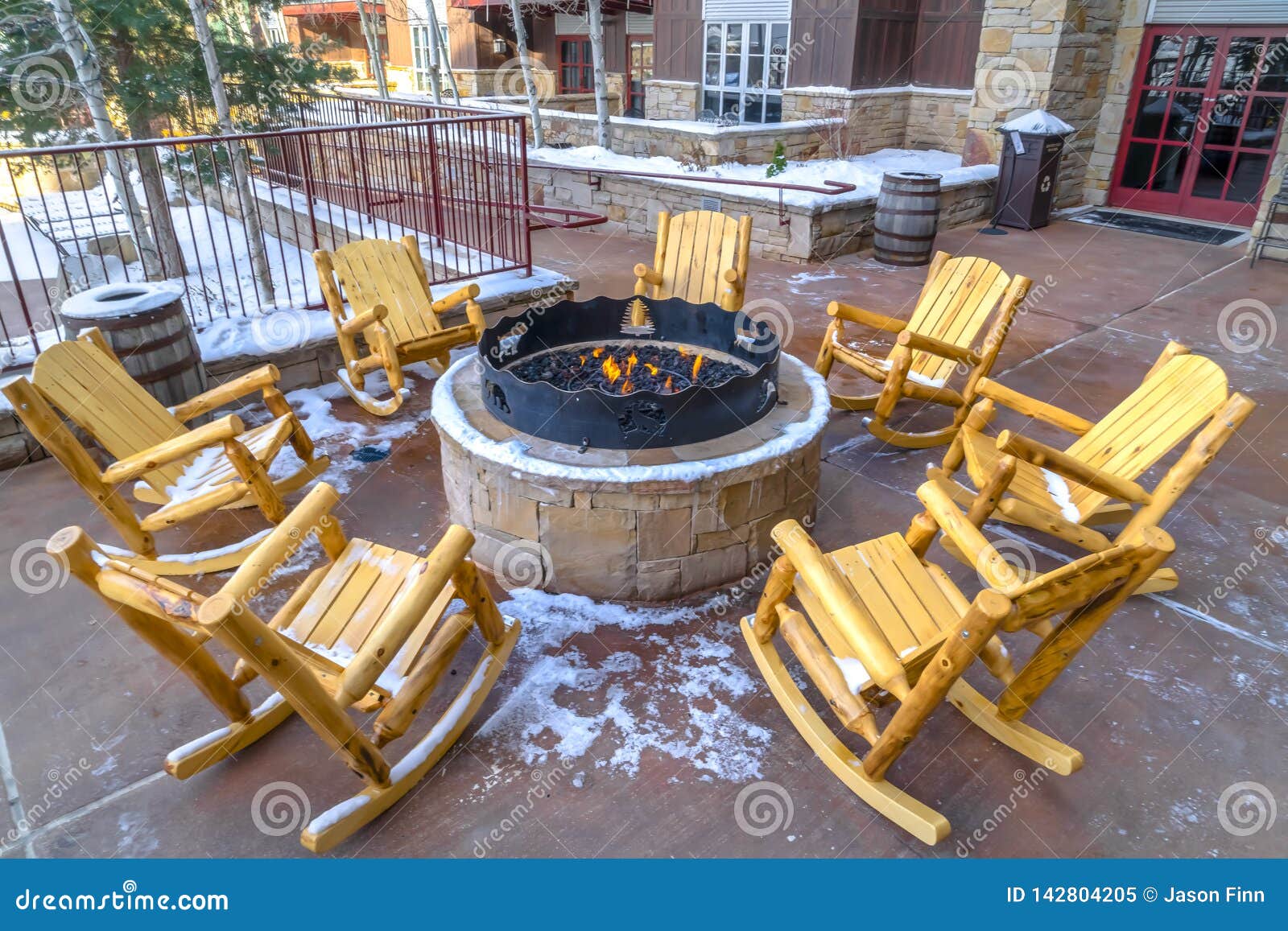 Patio with Wooden Rocking Chairs Around a Fire Pit Stock Image - Image