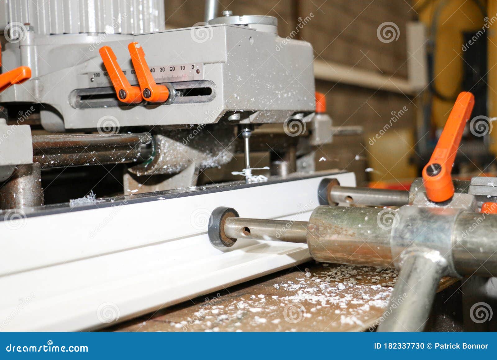 A Machine Produces Profiles in a PVC Joinery for the Construction of