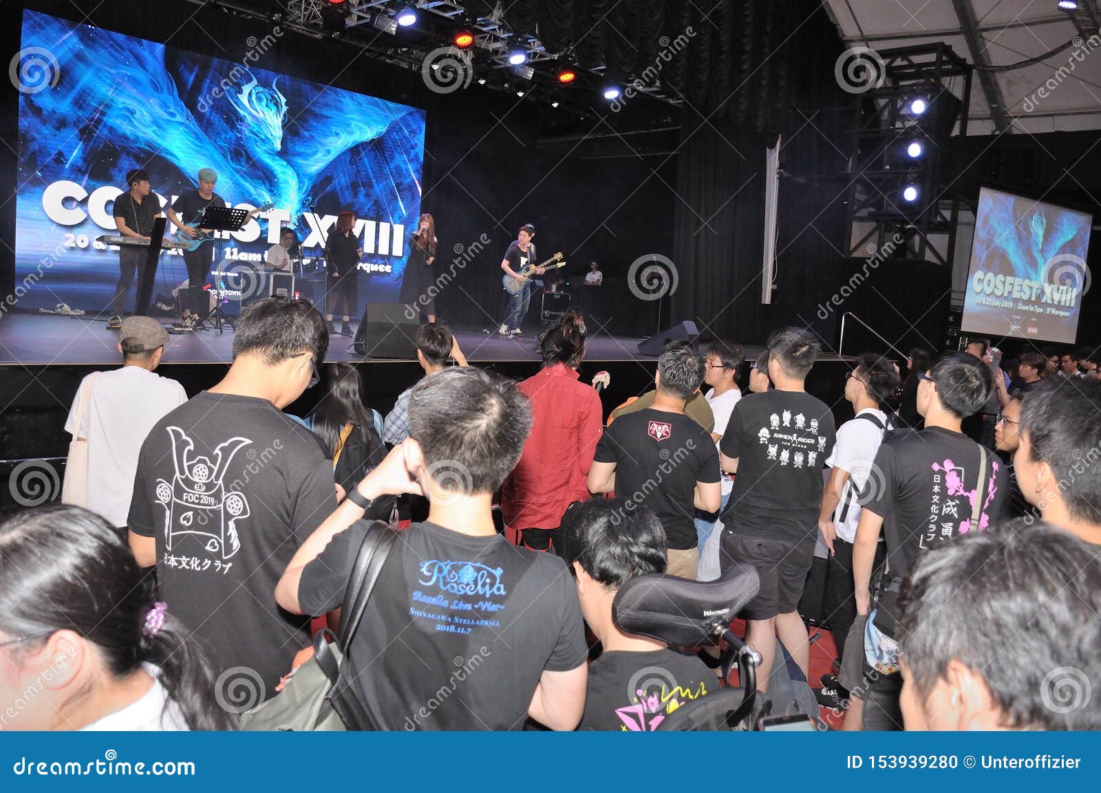 Patrons and Visitors Viewing a Performance on Stage at Cosfest in