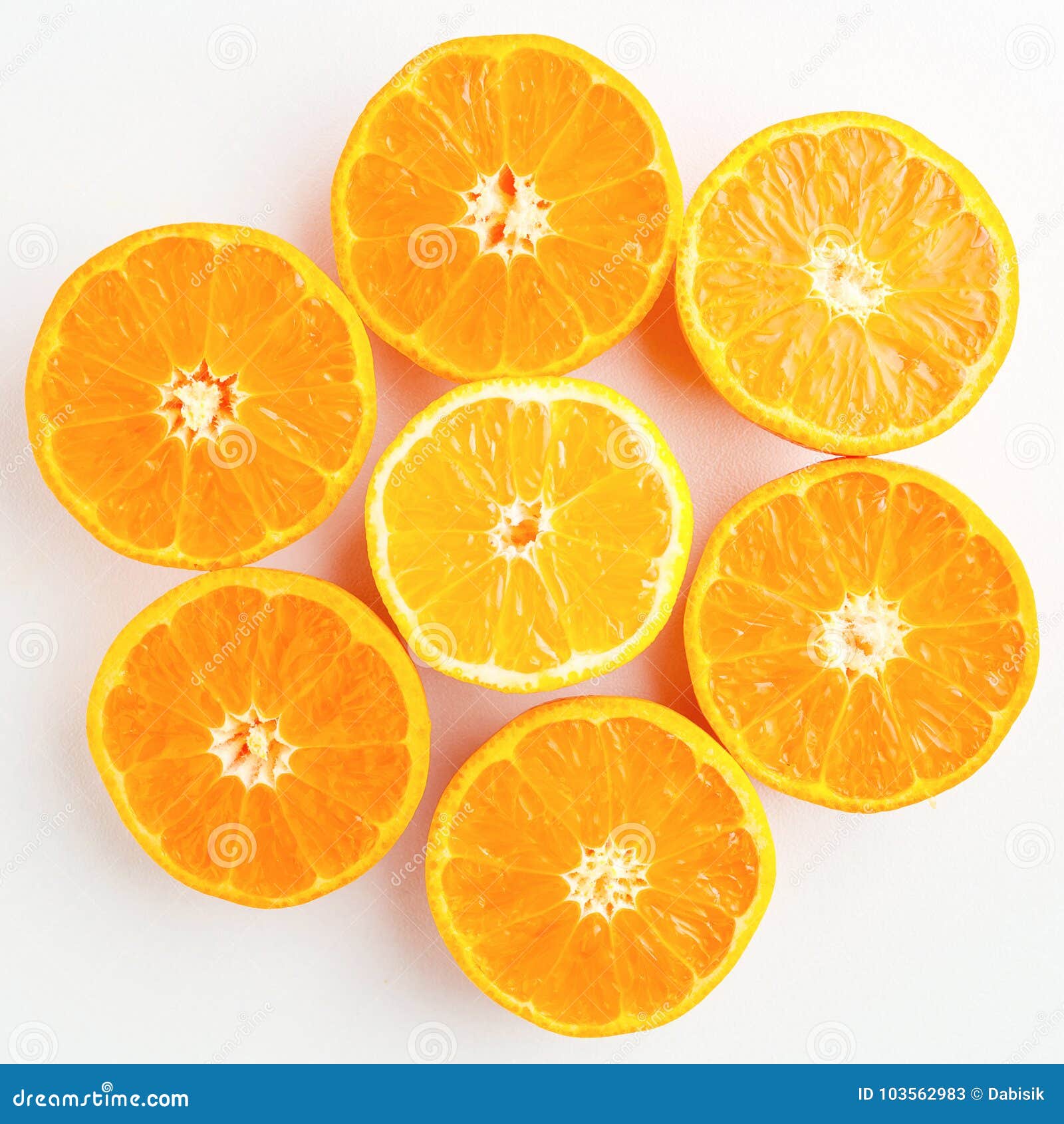 A Pattern of Orange and Yellow Mandarins Cut in Half on a White Stock
