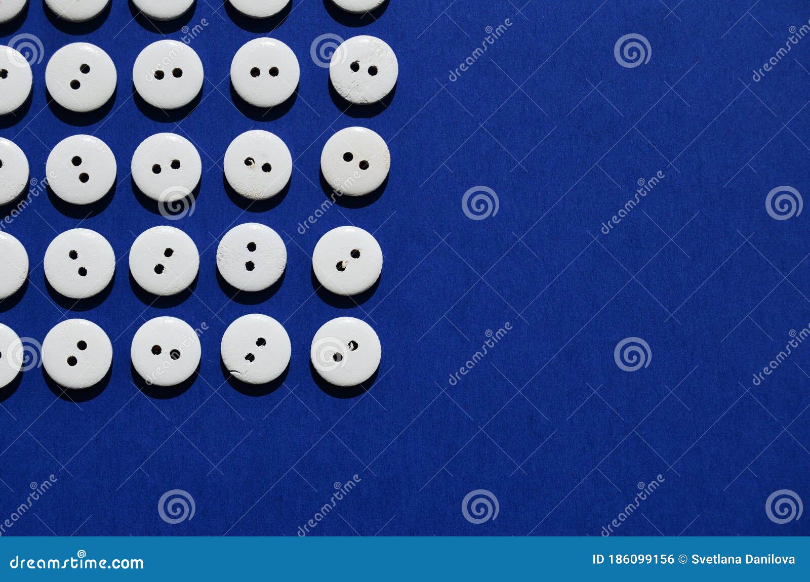 pattern white wooden pugosis in the top left corner on a blue background with a copy space stock photo image of group fashion 186099156 pattern white wooden pugosis in the top left corner on a blue background with a copy space stock photo image of group fashion 186099156