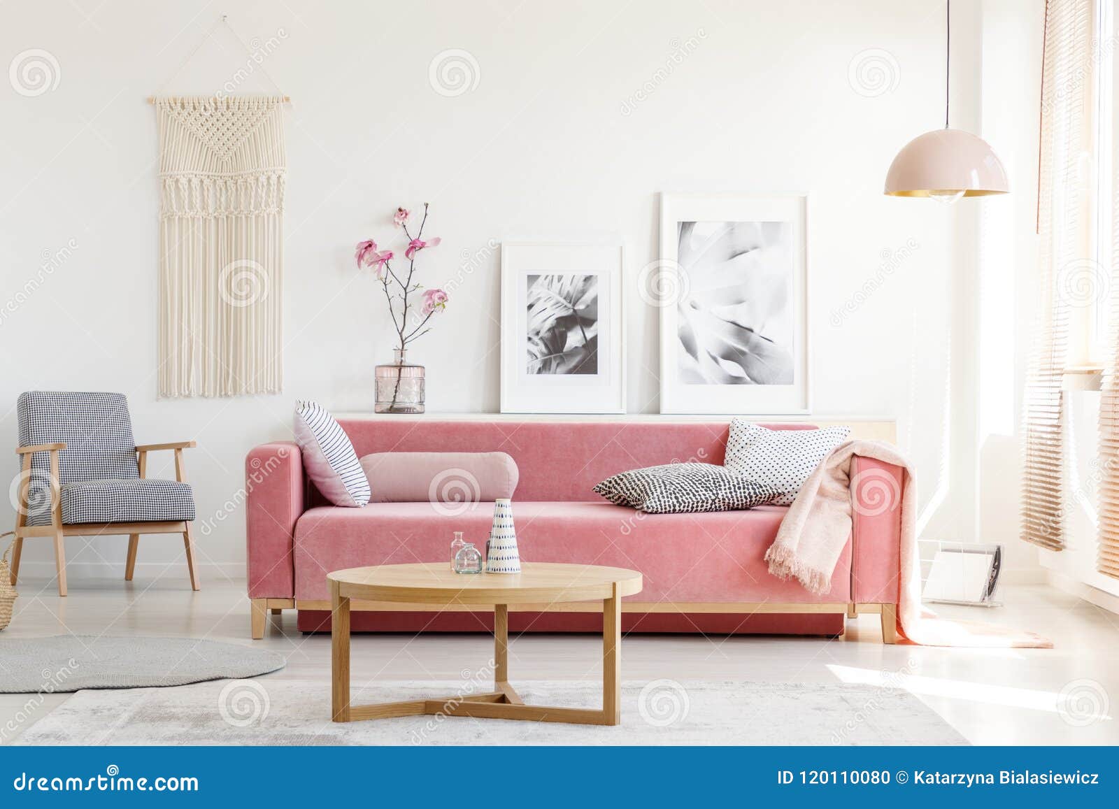 patterned armchair and pink couch in feminist apartment interior