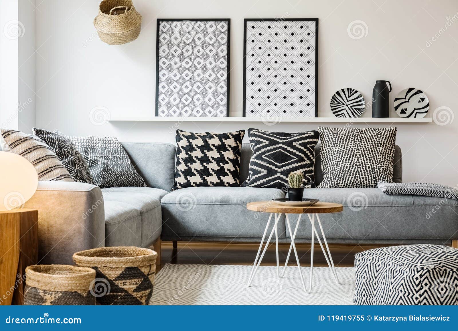 Patterned Pillows On Grey Corner Sofa In Apartment Stock