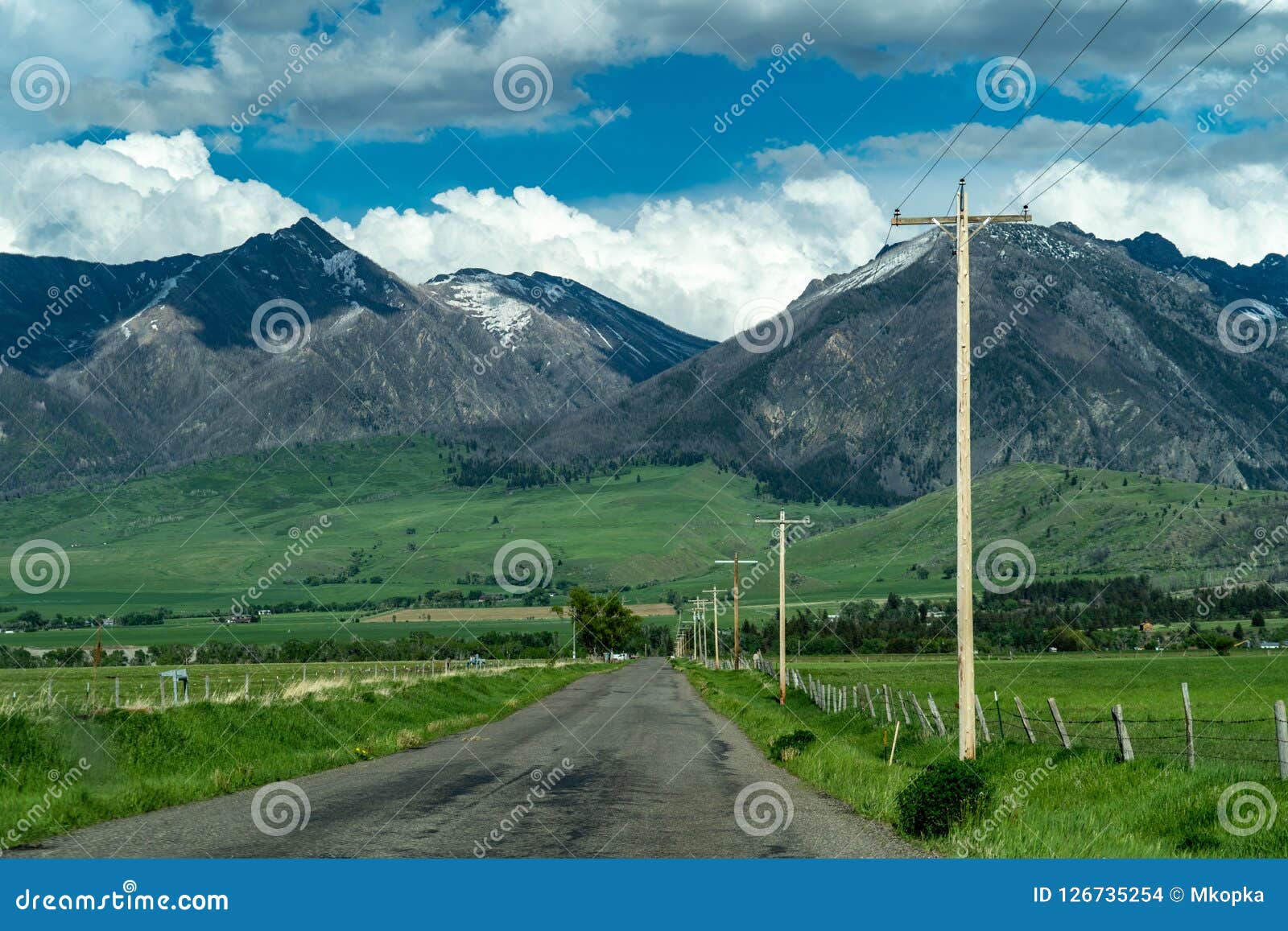 paved road with leading into the absaroka mountain range near livingston montana in paradise valley