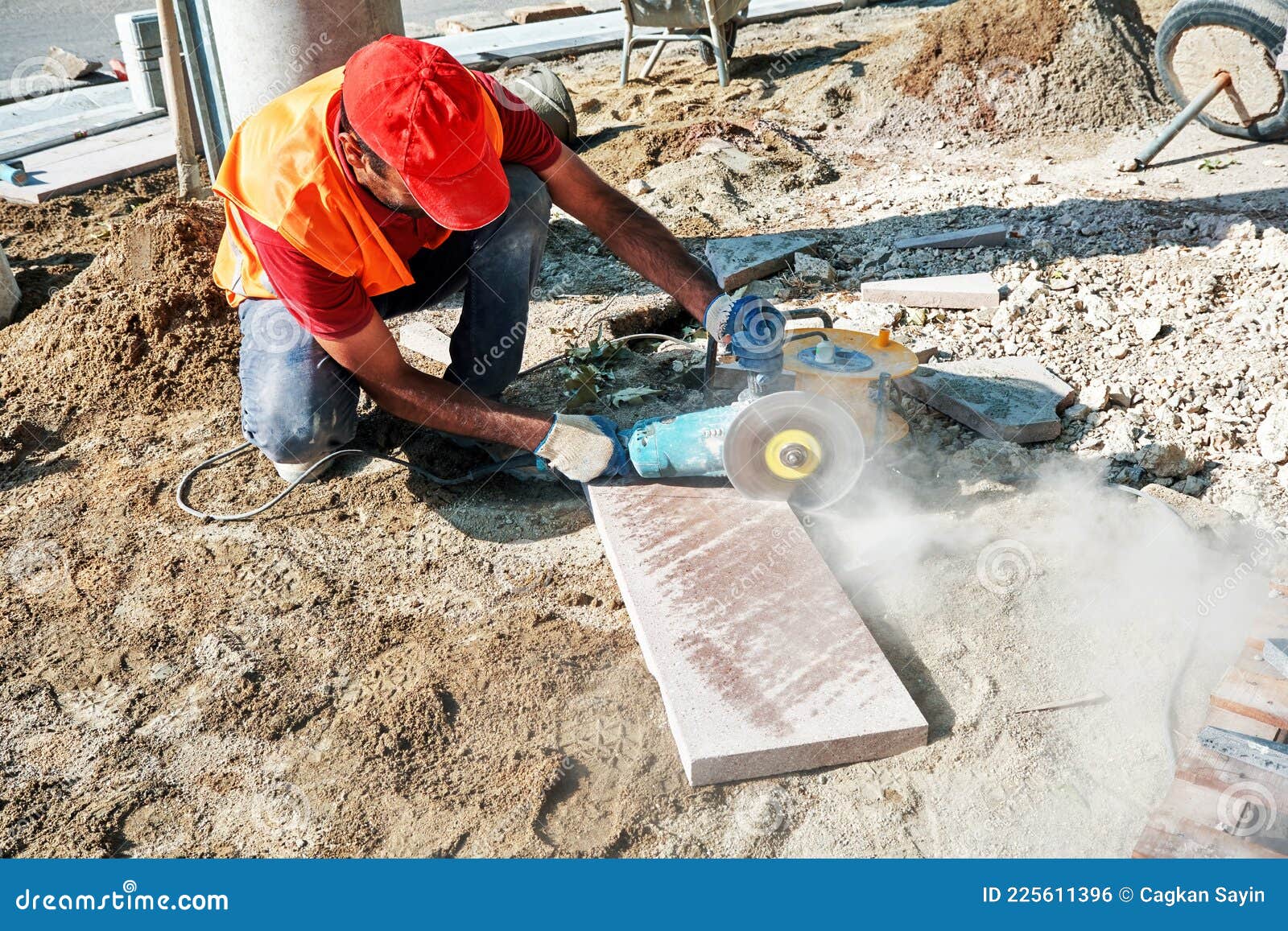 Pavement Construction Worker Using an Angle Grinder for Cutting the