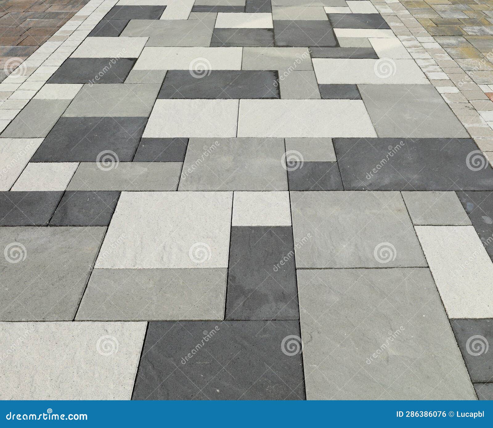 Pavement Made of Black, White and Gray Concrete Tiles for Outdoors