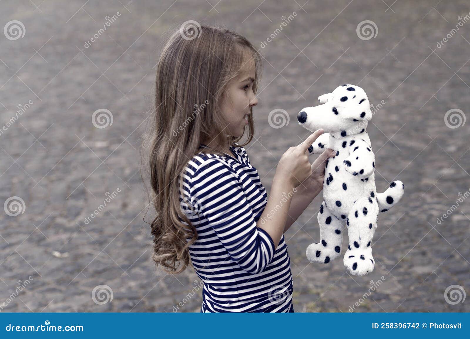 Paying is State of Being. Little Child Play with Toy Dog Outdoors