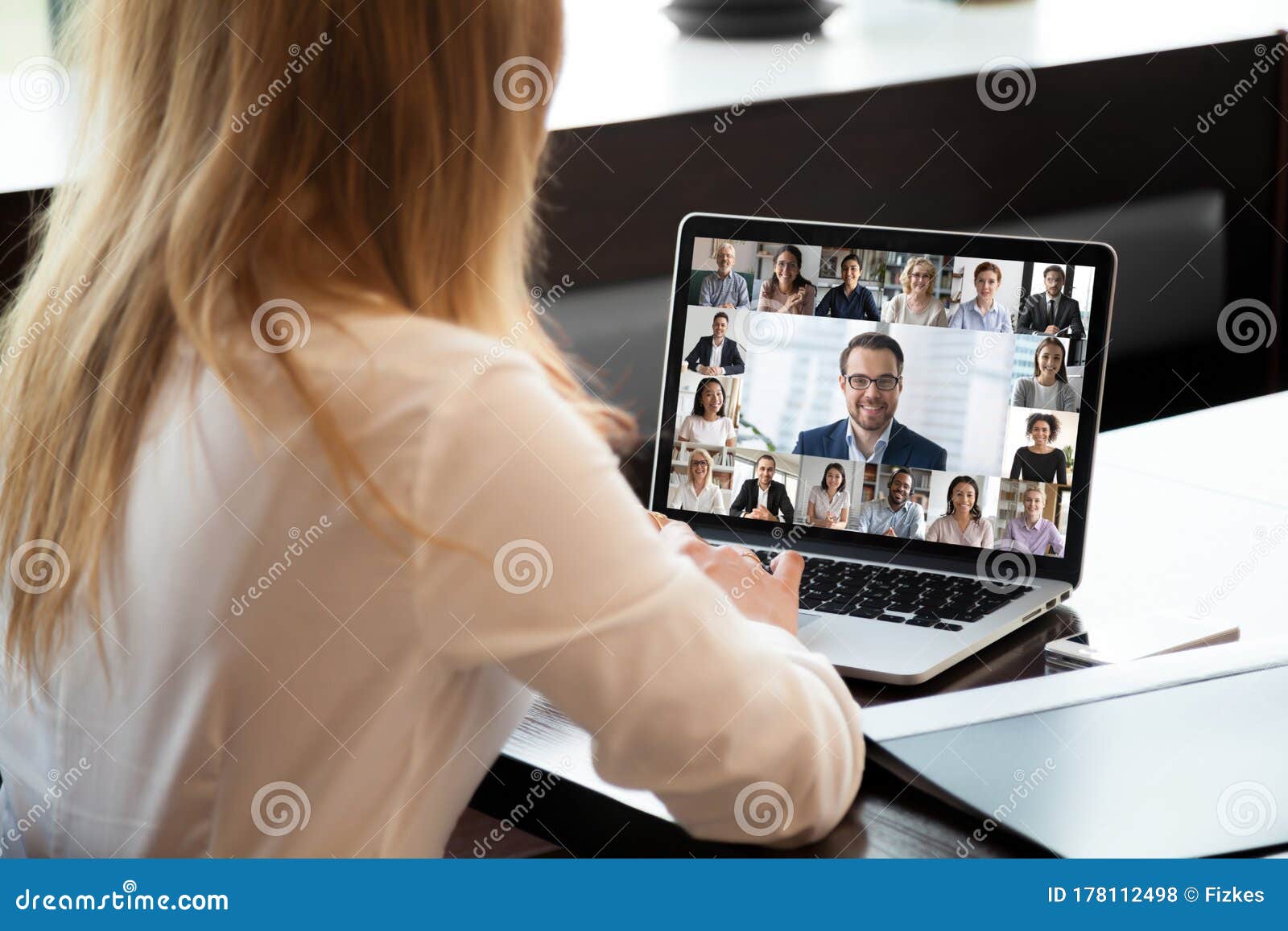 people engaged in group videocall, laptop screen webcam application view