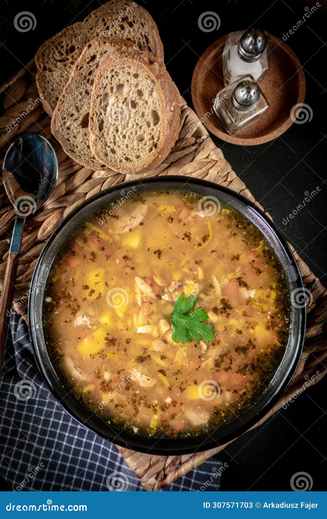 pea soup with pieces of white sausage, potatoes and small dumplings