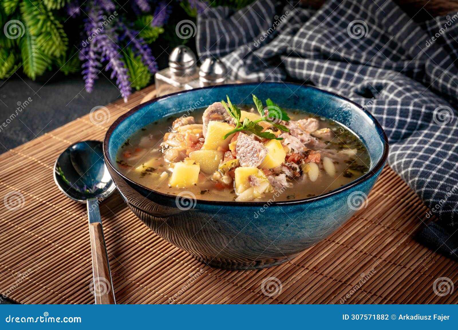 pea soup with pieces of white sausage, potatoes and small dumplings