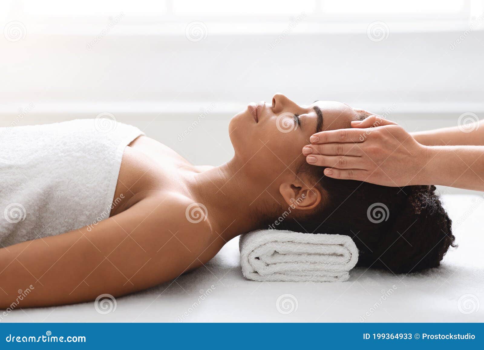 Peaceful African American Woman Getting Healing Head Massage At Spa