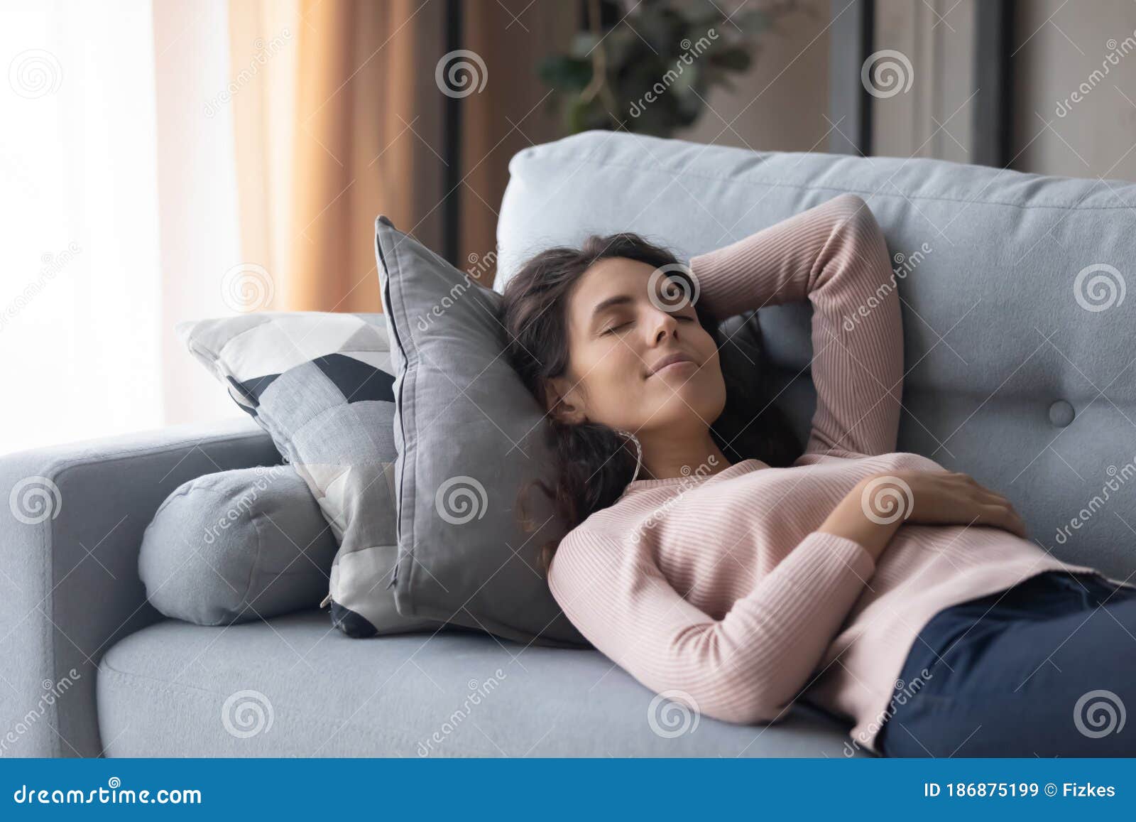 Peaceful Beautiful Woman Sleeping On Cozy Couch In Living Room Stock