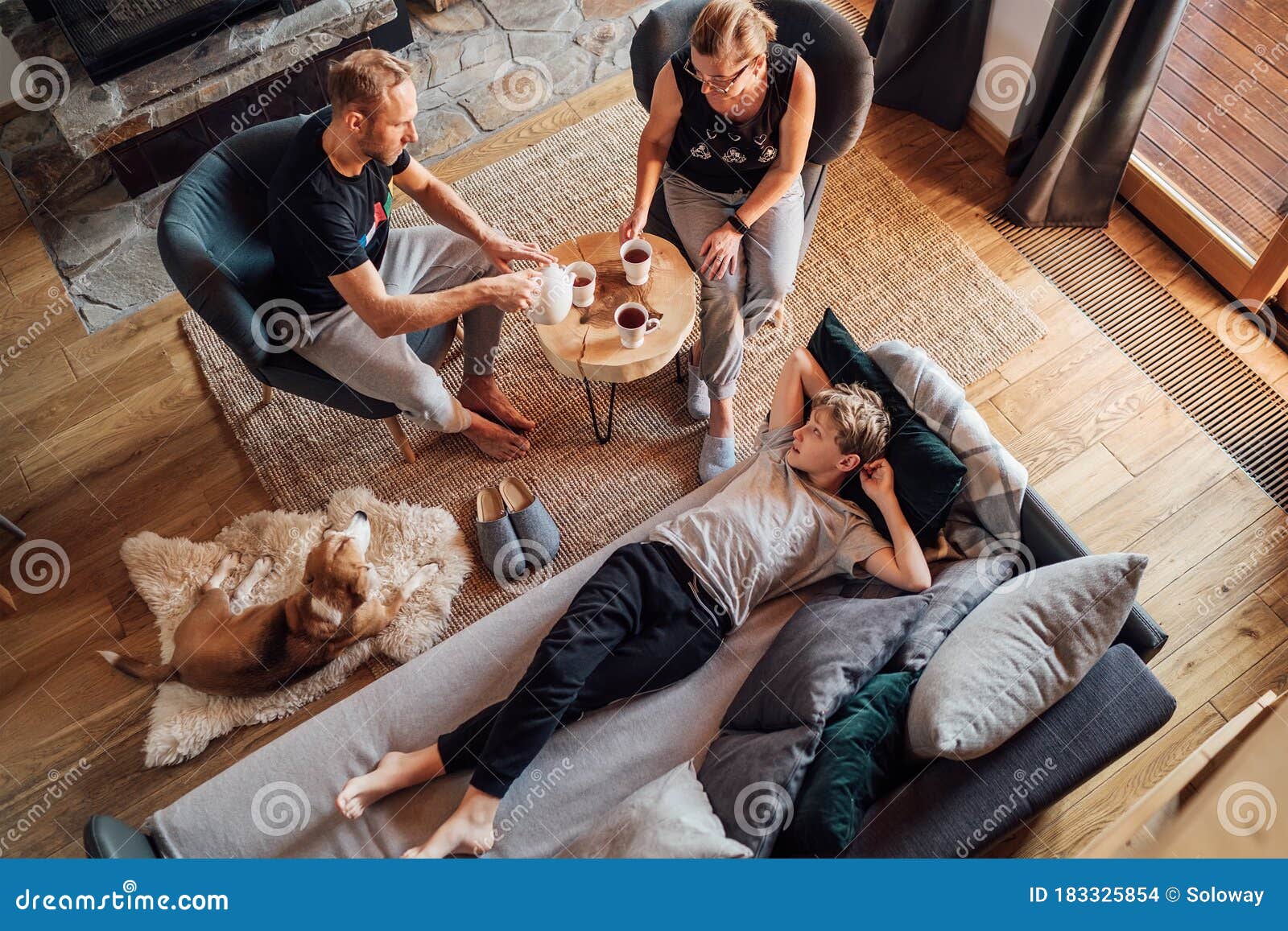 Peaceful Family Moments Concept Image. Cozy Family Drinking Tea Time