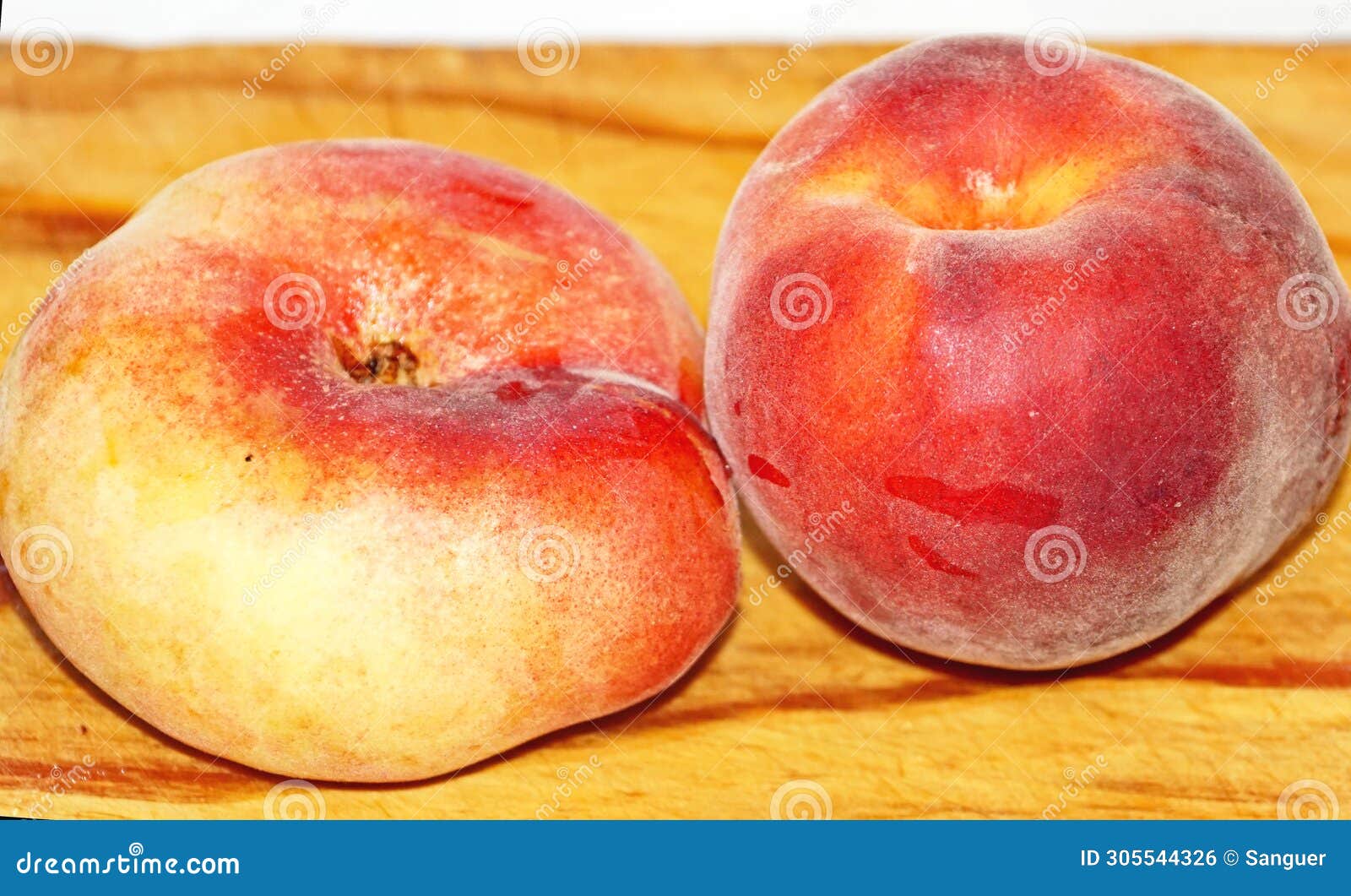peach and paraguayan on a cutting board in the kitchen