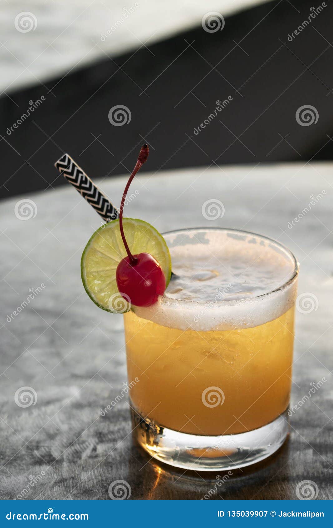 Peach Screwdriver Mixed Vodka Cocktail Drink Outdoors at Sunset Stock