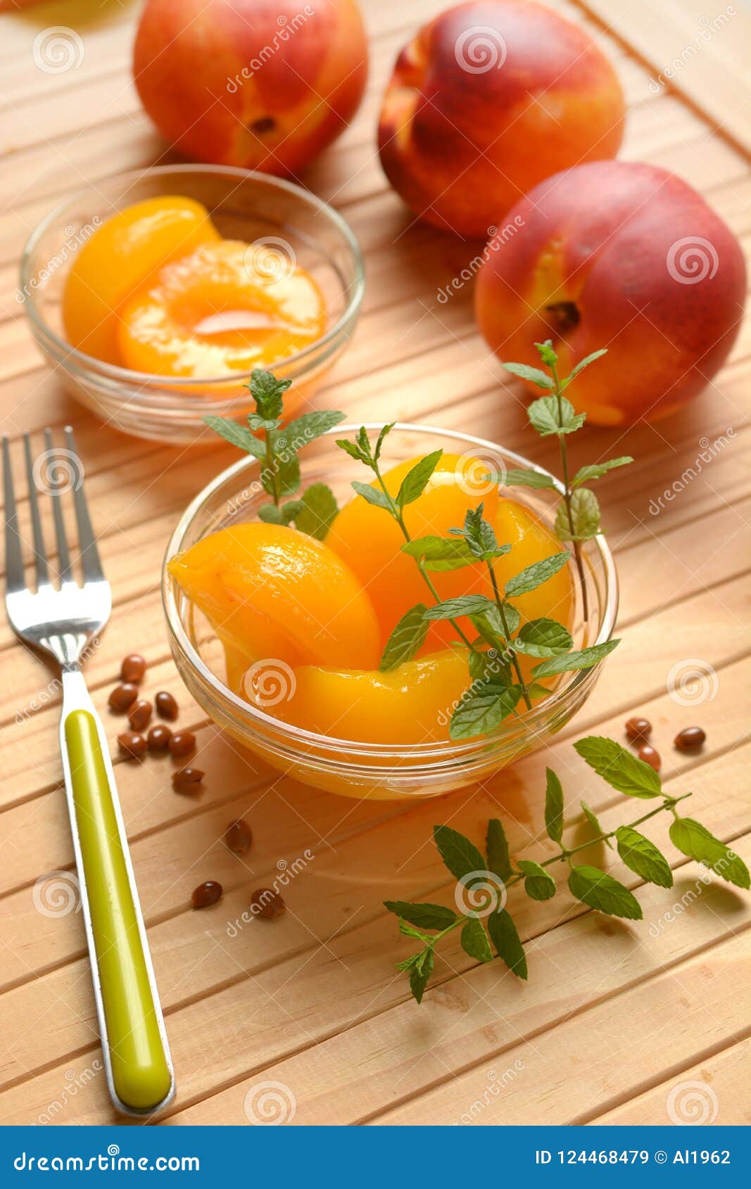 Peaches in Syrup in the Glass Bowl with Fruit Around Stock Image
