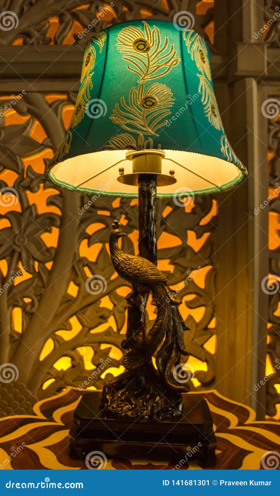 Peacock Table Lamp with Cut Work Wall Art Backlit in the Background