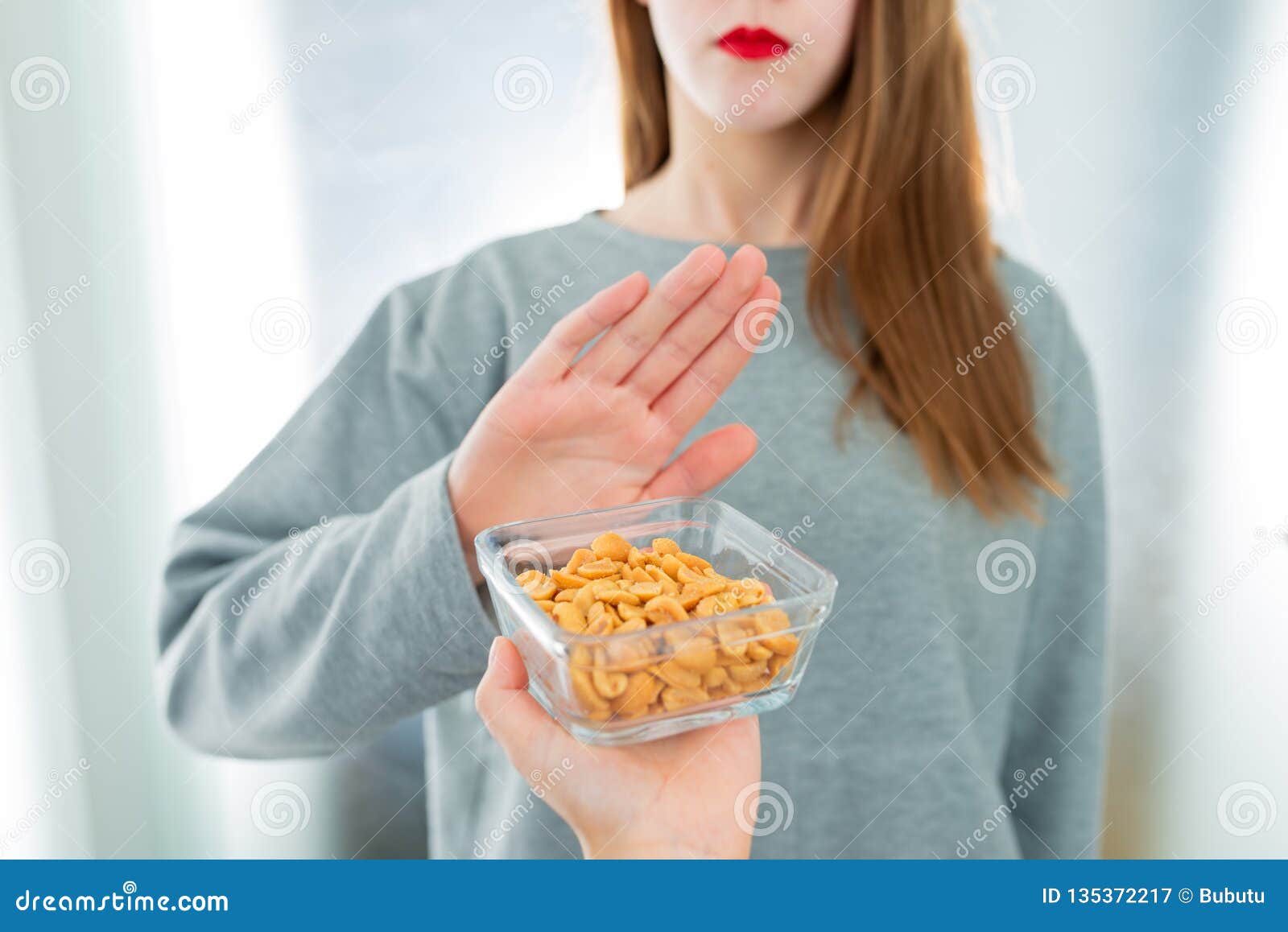 peanut allergy concept - food intolerance. young girl refuses to eat peanuts