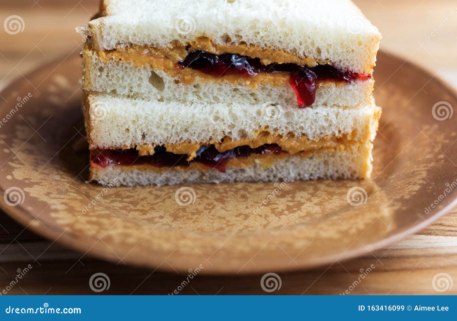 Peanut Butter And Jelly Sandwich On White Bread Cut In Half And Stacked Close Up View Stock Image Image Of Childhood Jelly