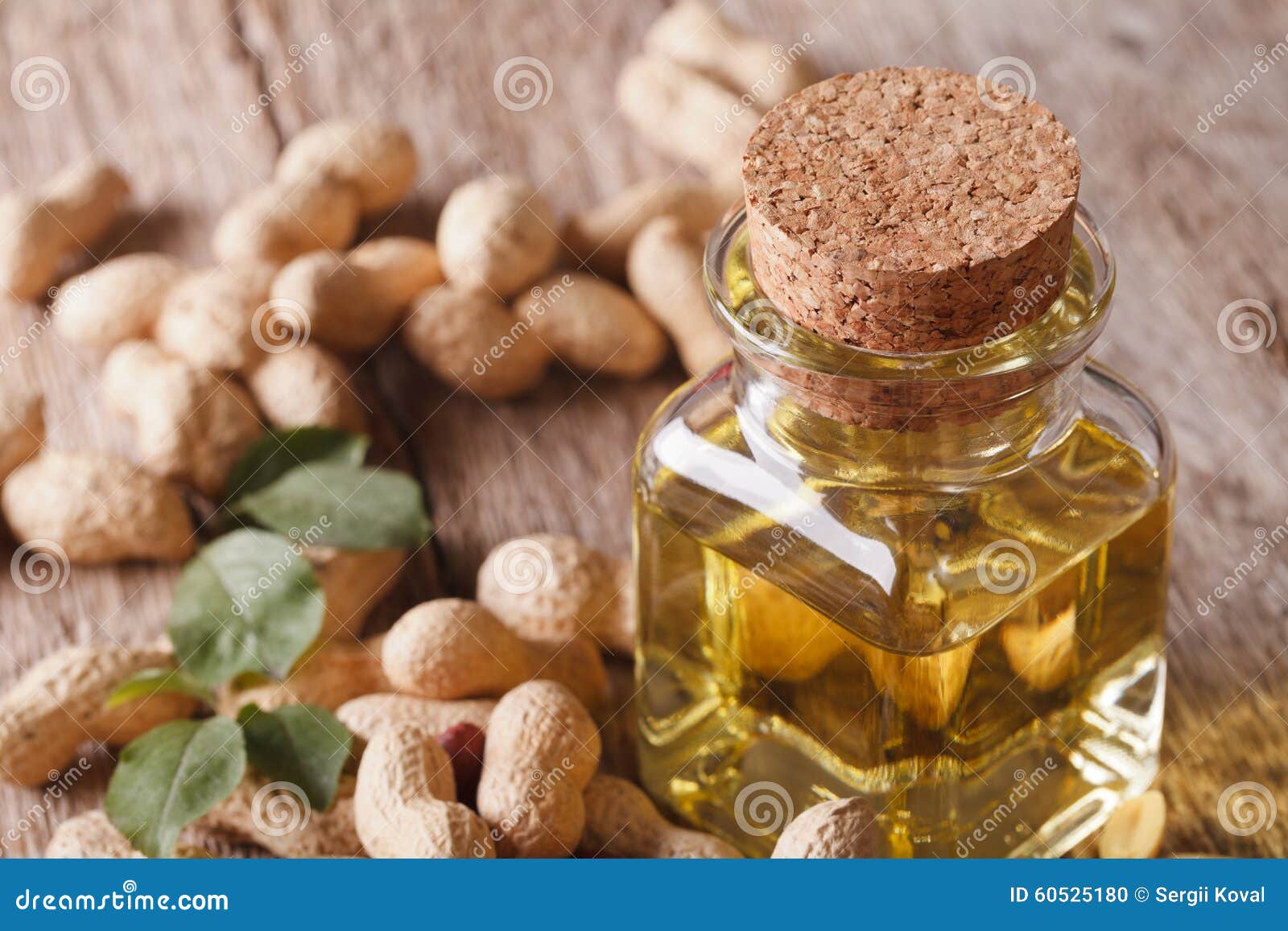 Peanut Oil in a Glass Bottle on a Table Macro. Horizontal Stock Photo