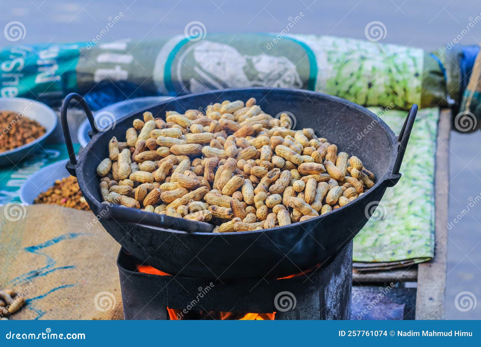 A Peanut Seller Keeps Frying Peanuts in a Van, Fried Peanuts Stock