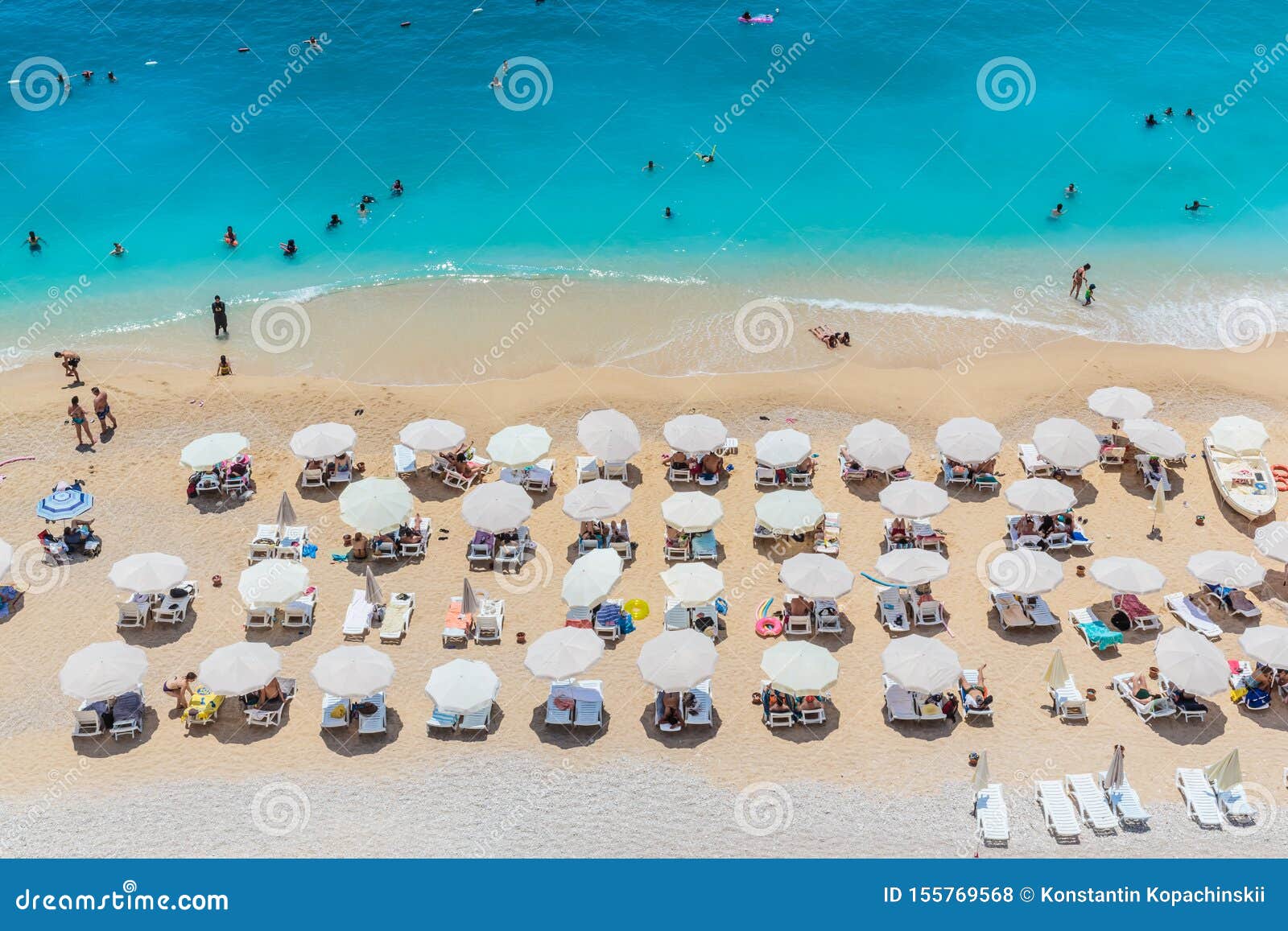 peaople resting on the beach, umbrella rows, kaputash, turkey
