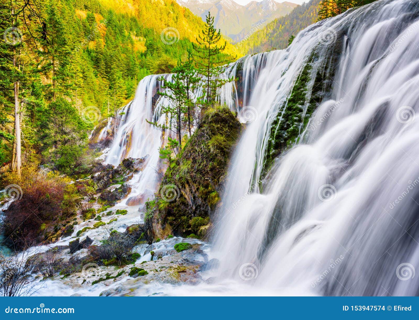 The Pearl Shoals Waterfall Among Wooded Mountains At Sunset Stock Photo