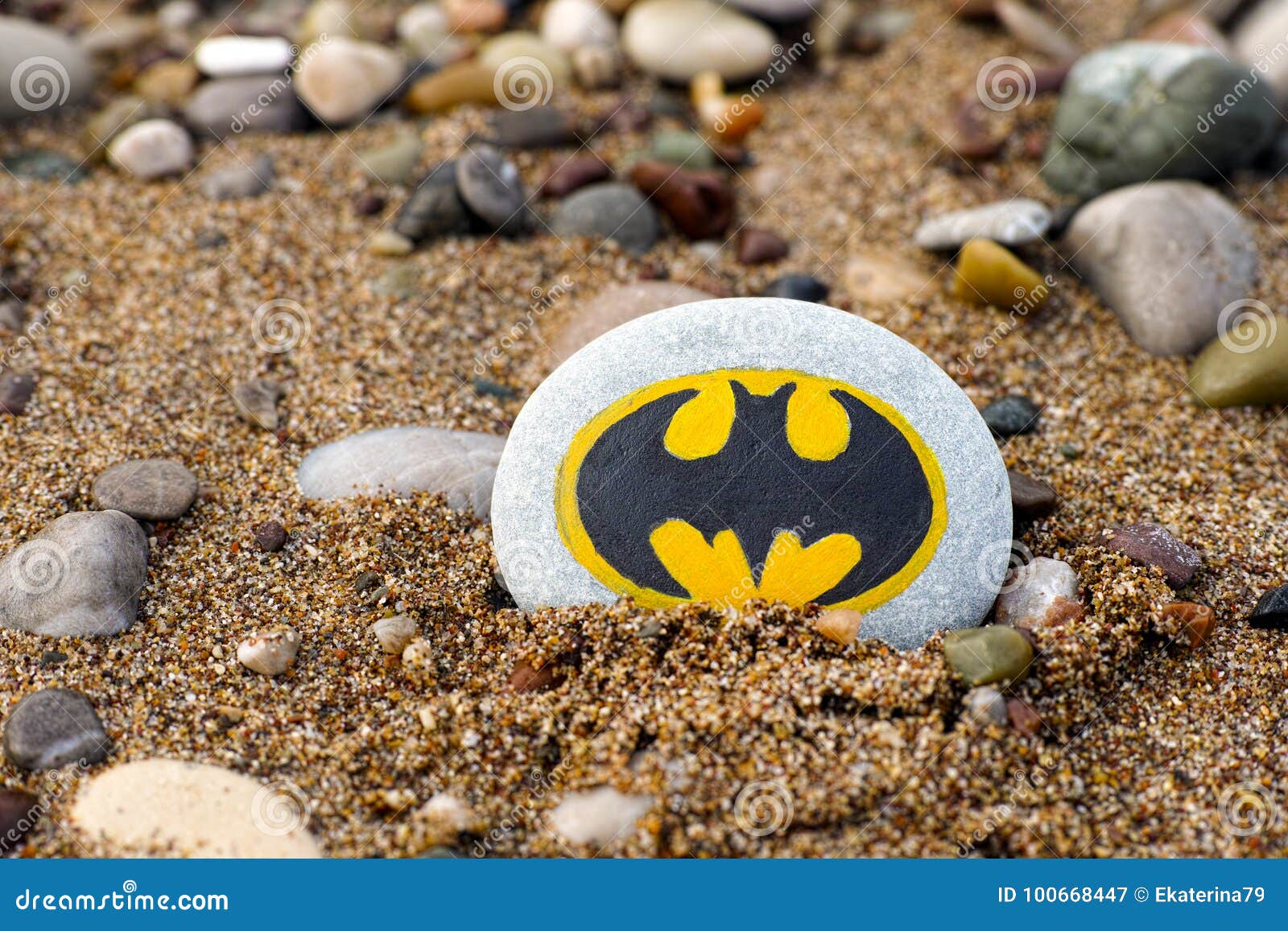 Pebble with Painted Sign Batman on Beach with Sand and Pebbles Editorial  Photography - Image of super, batman: 100668447