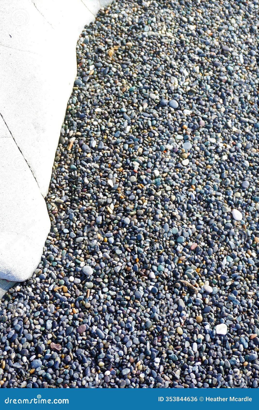 pebbles collection and large white stone in stony beach environment