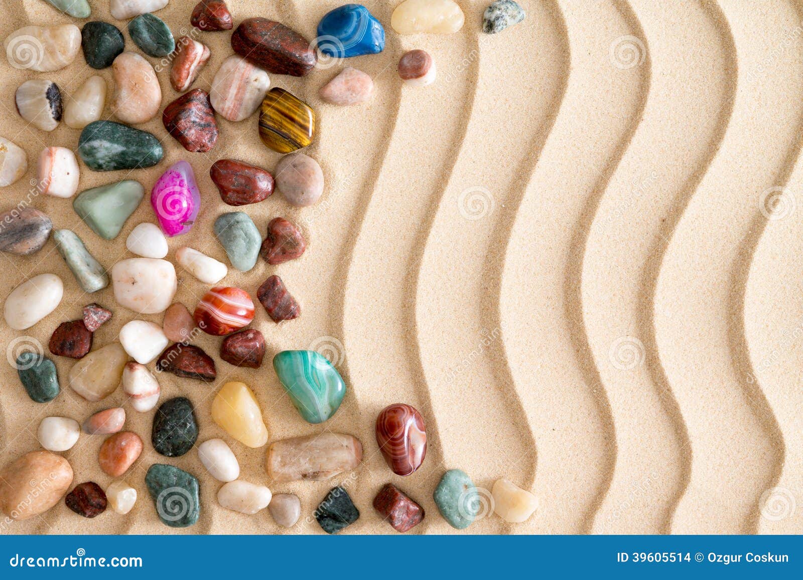 pebbles and gemstones on golden beach sand