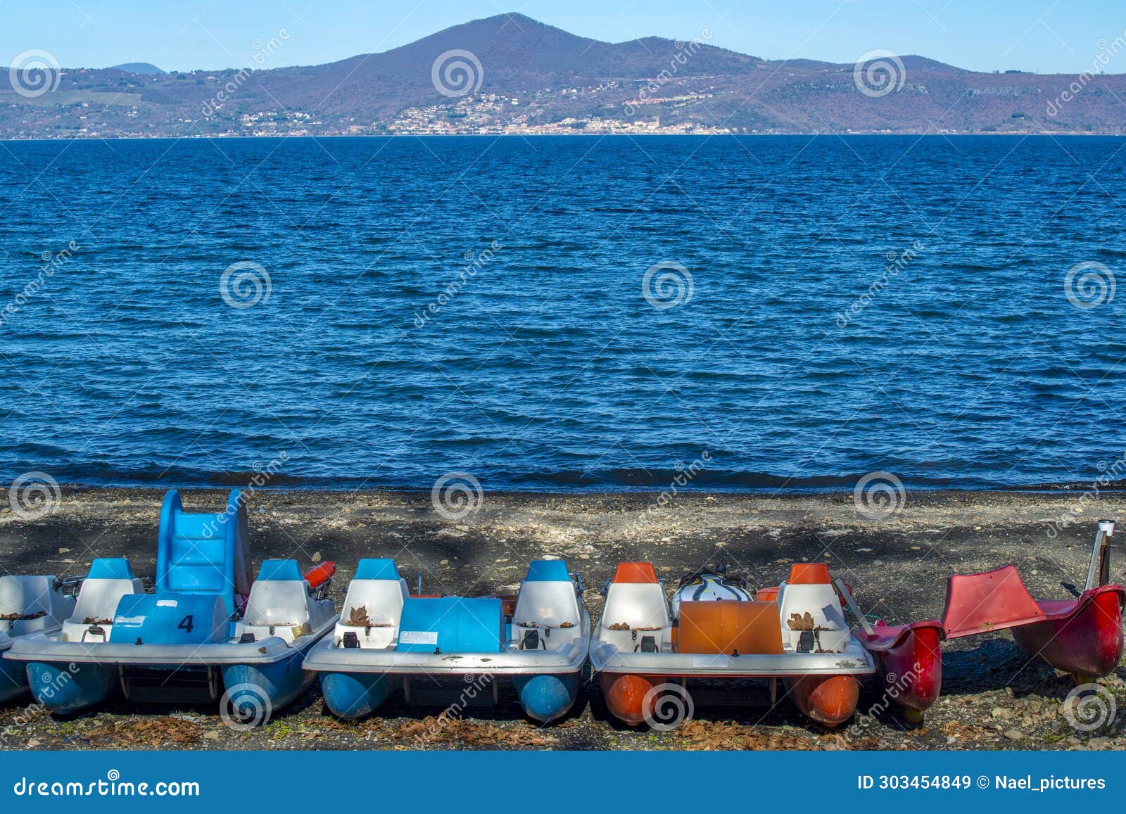 pedalos on the beach of the village of anguillara sabazia on the shores of lake bracciano in italy