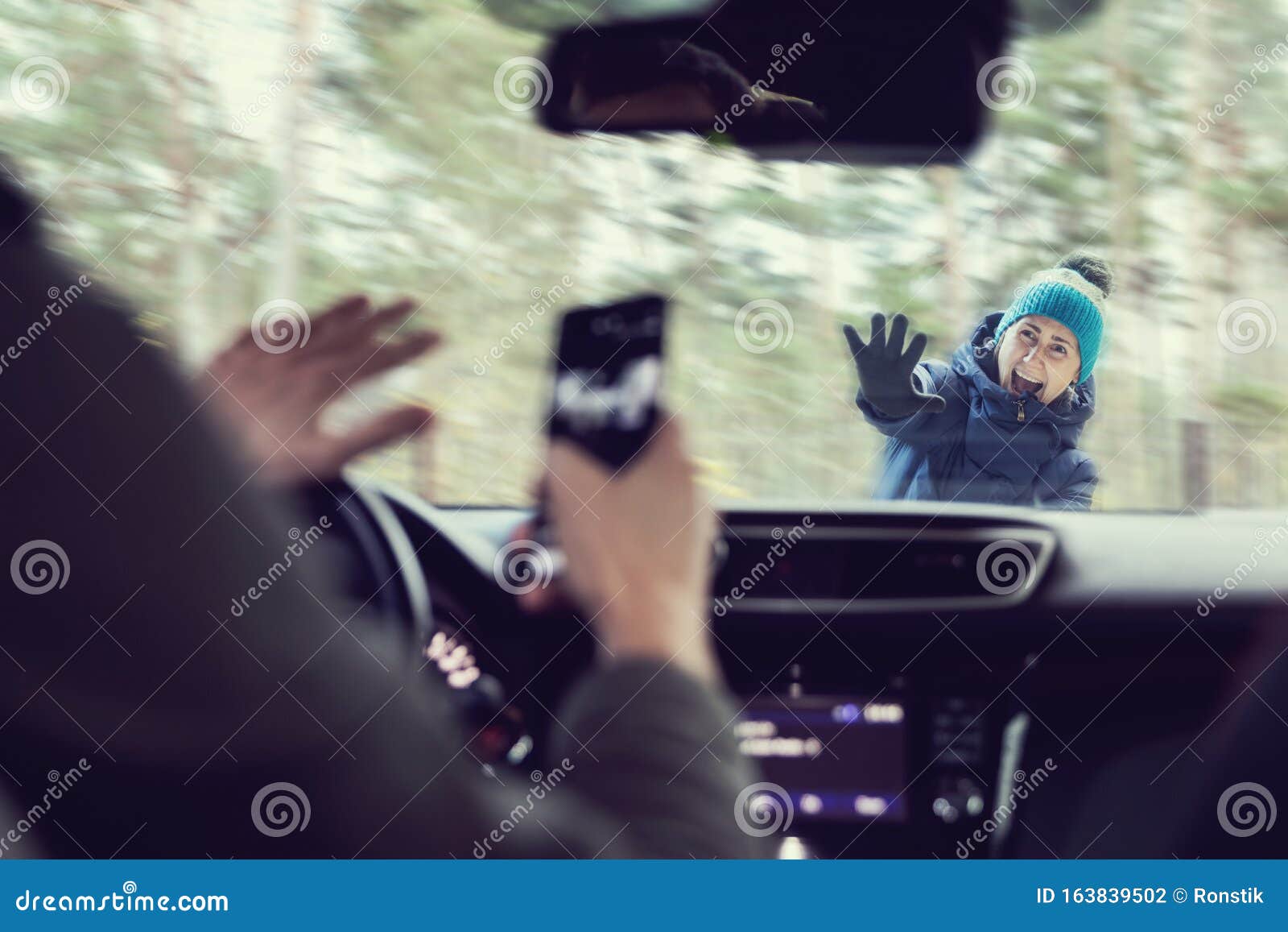 pedestrian accident - man using a phone while driving a car