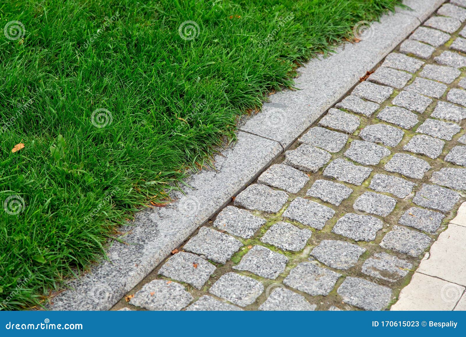 a pedestrian pavement made of stone cobble and granite tiles.