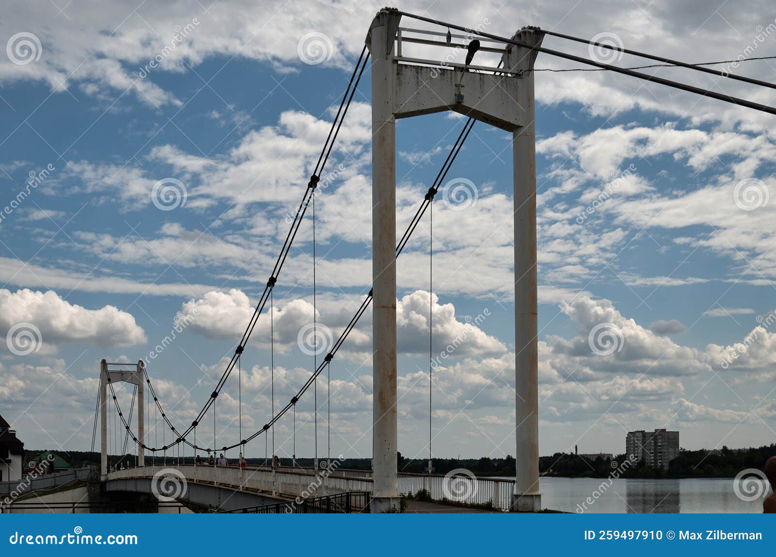 Pedestrian Suspension Bridge Across the River in the City Stock Photo