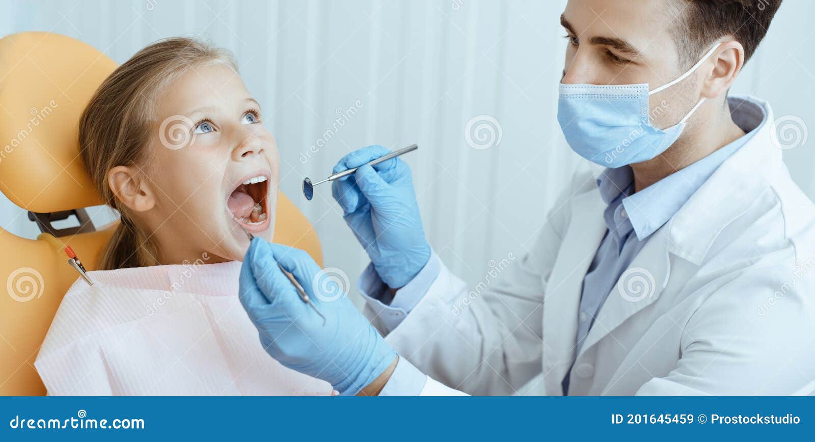 pediatric dentistry and examination of teeth of small patient