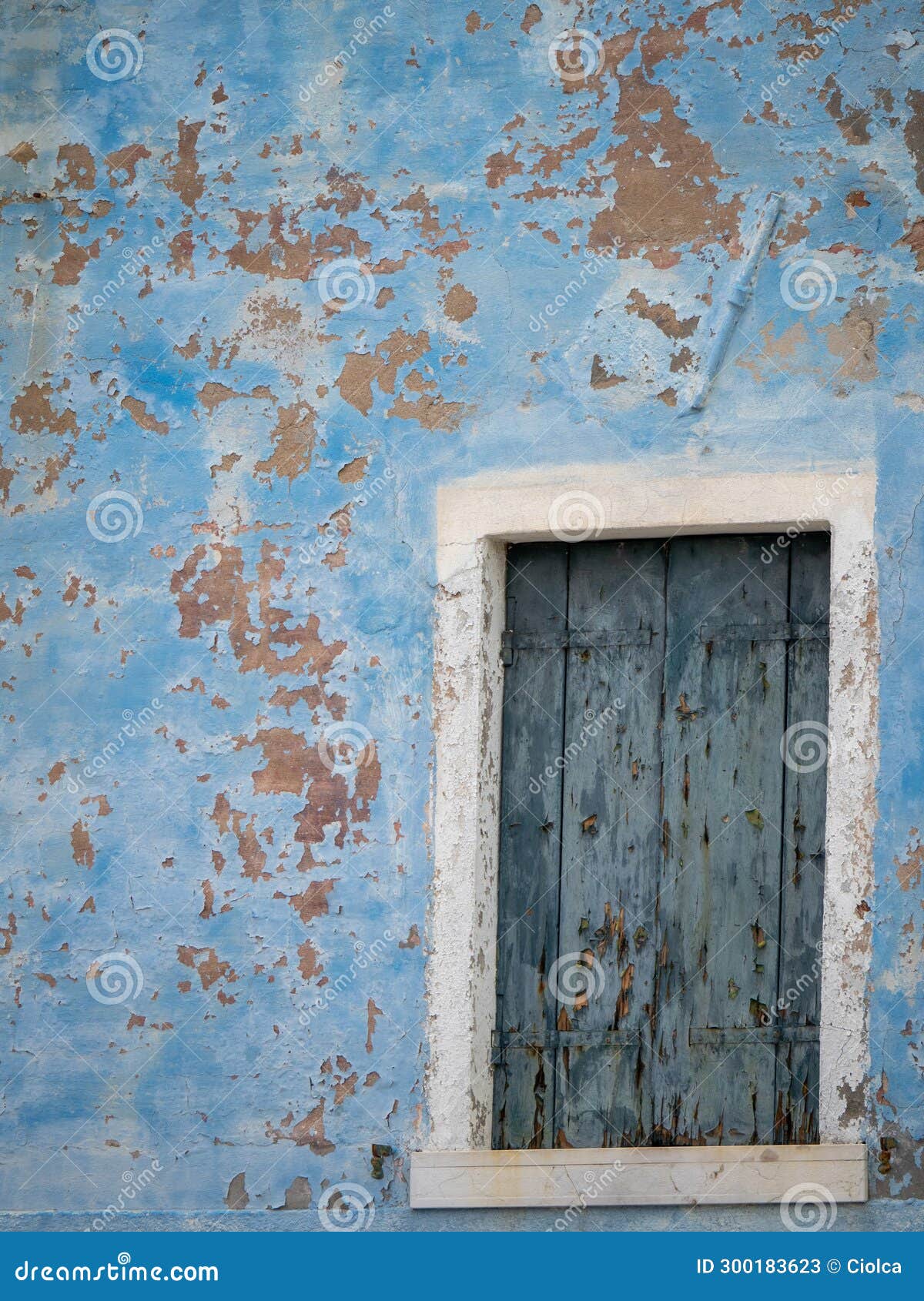 peeled blue window wall